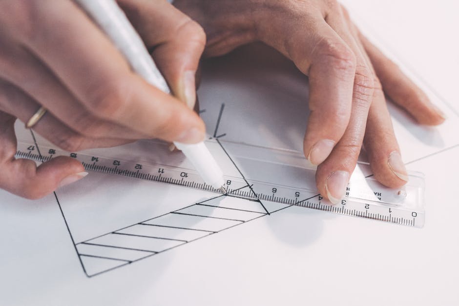 Close-up of hands drawing precise lines with ruler and pen, emphasizing accuracy.